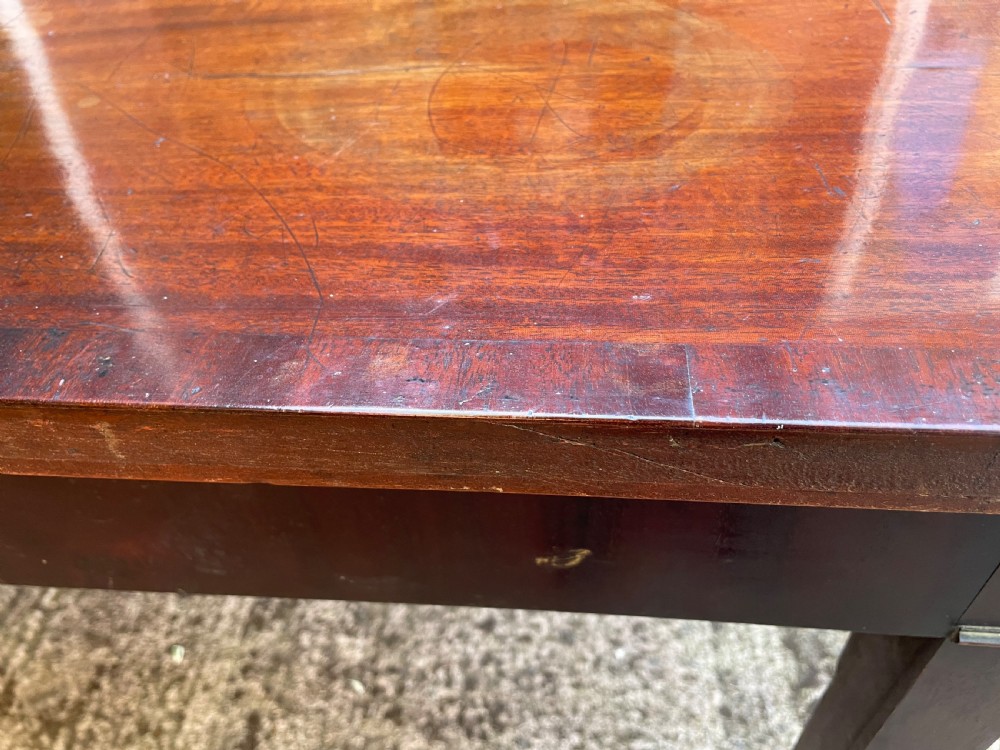 A late 18th-century George III mahogany pier table featuring fluted legs, carved corner brackets, and a rectangular polished top. View XVII