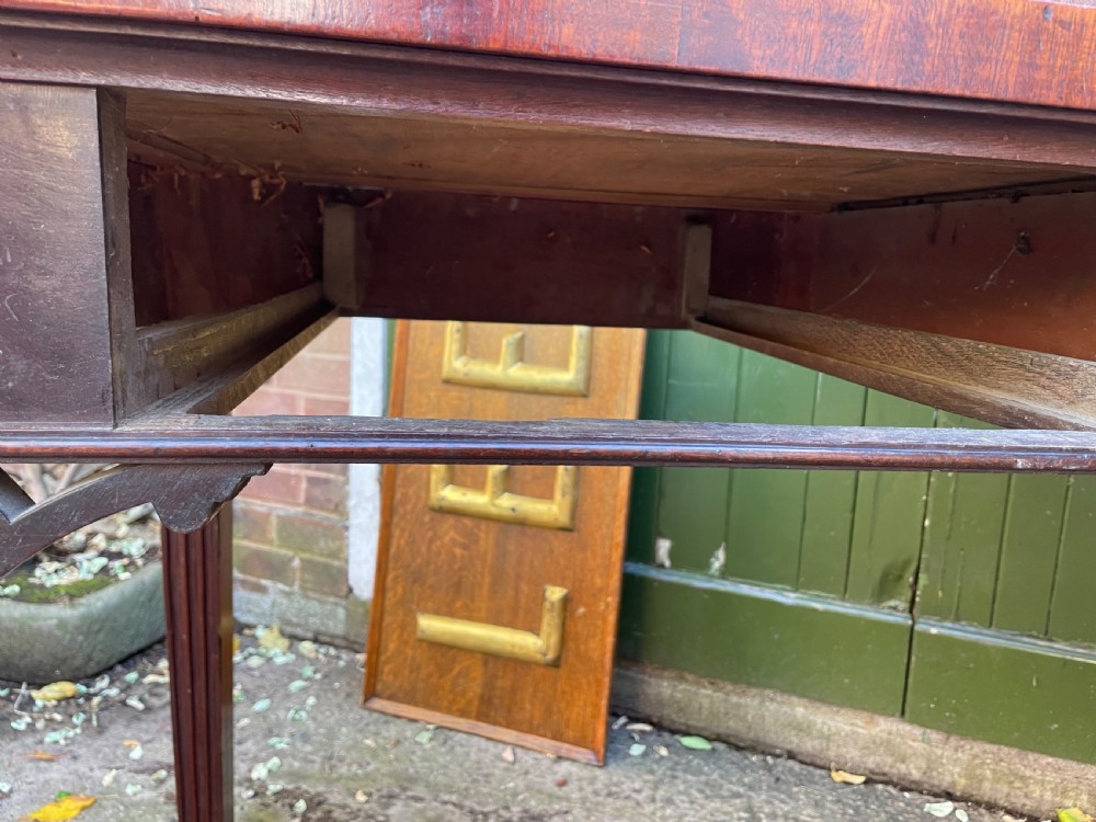 A late 18th-century George III mahogany pier table featuring fluted legs, carved corner brackets, and a rectangular polished top. View XXII