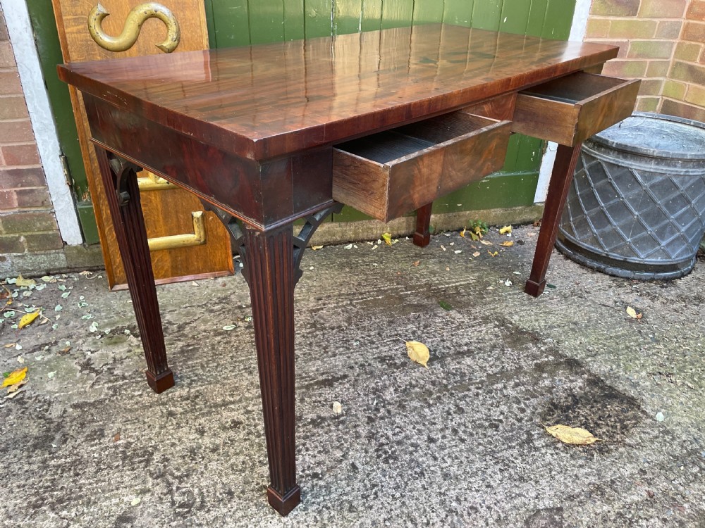 A late 18th-century George III mahogany pier table featuring fluted legs, carved corner brackets, and a rectangular polished top. View XXIII