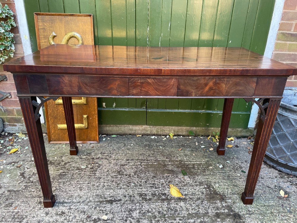 A late 18th-century George III mahogany pier table featuring fluted legs, carved corner brackets, and a rectangular polished top. View XXIV