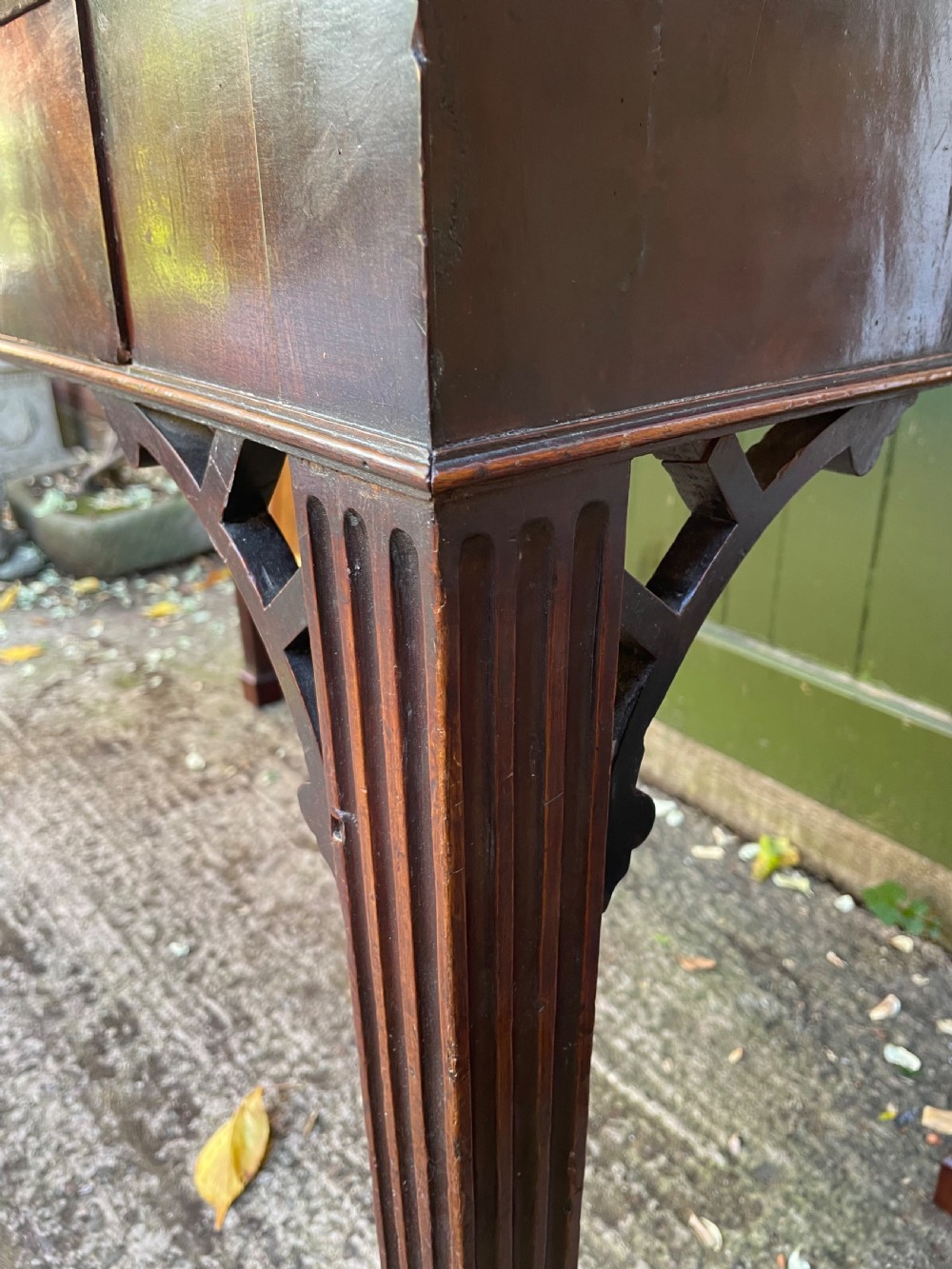 A late 18th-century George III mahogany pier table featuring fluted legs, carved corner brackets, and a rectangular polished top. View XXV