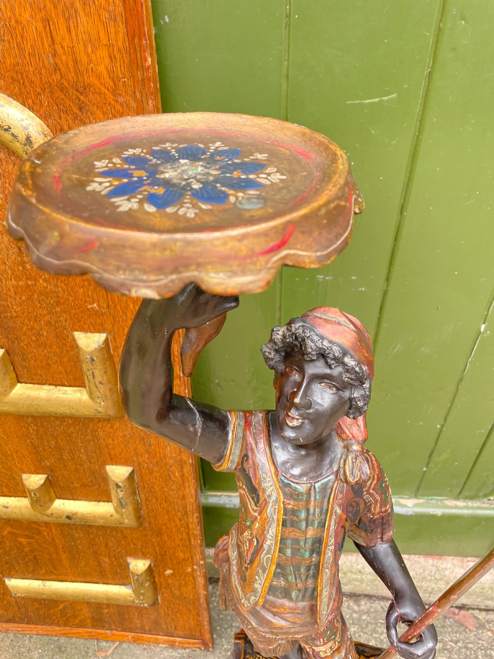 A late 19th-century Italian Venetian carved wood polychrome figure of a gondolier standing on a boat base atop a plinth, holding an oar and raised tray. View III