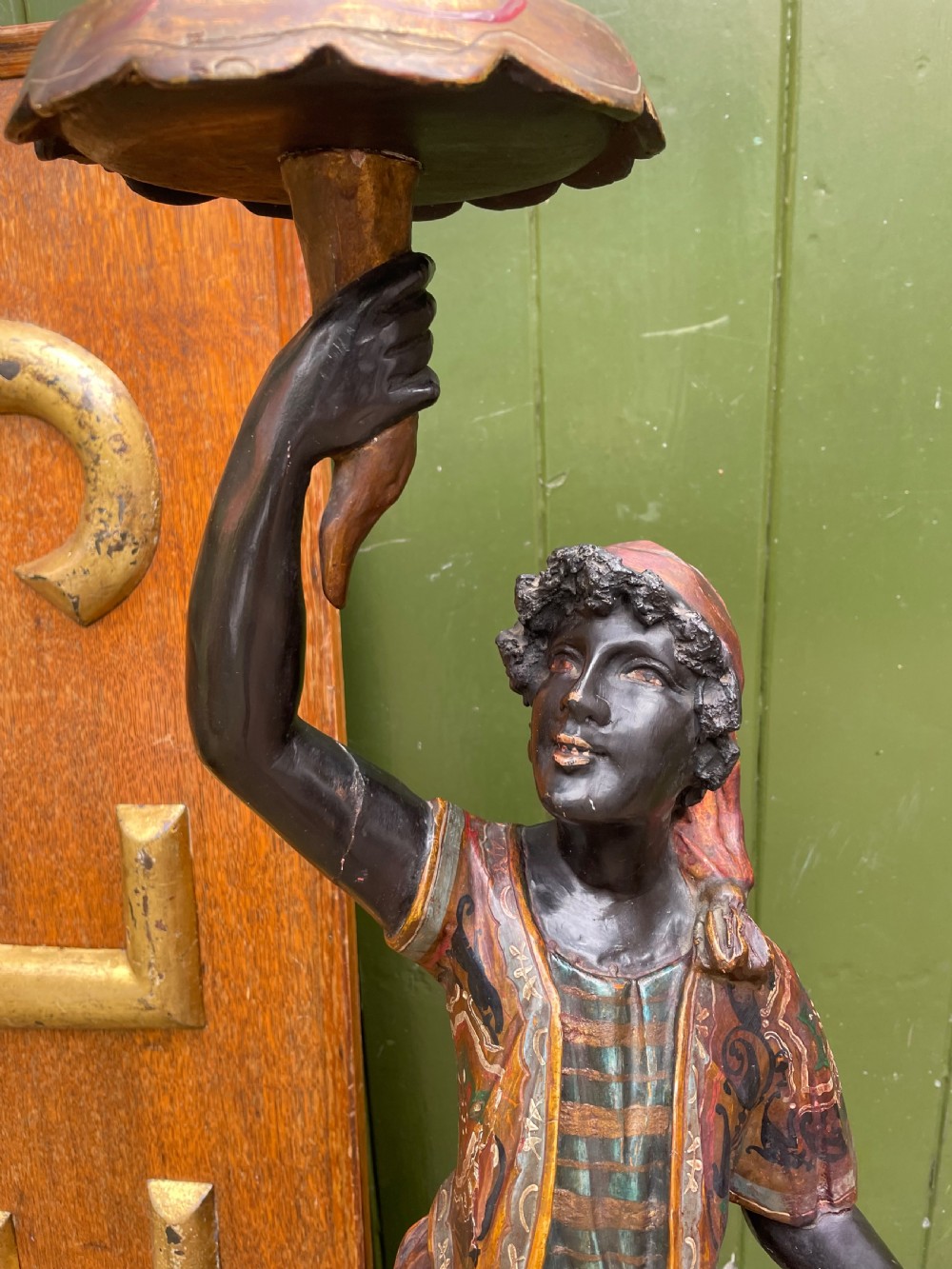 A late 19th-century Italian Venetian carved wood polychrome figure of a gondolier standing on a boat base atop a plinth, holding an oar and raised tray. View VII