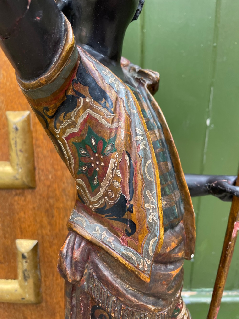 A late 19th-century Italian Venetian carved wood polychrome figure of a gondolier standing on a boat base atop a plinth, holding an oar and raised tray. View XI