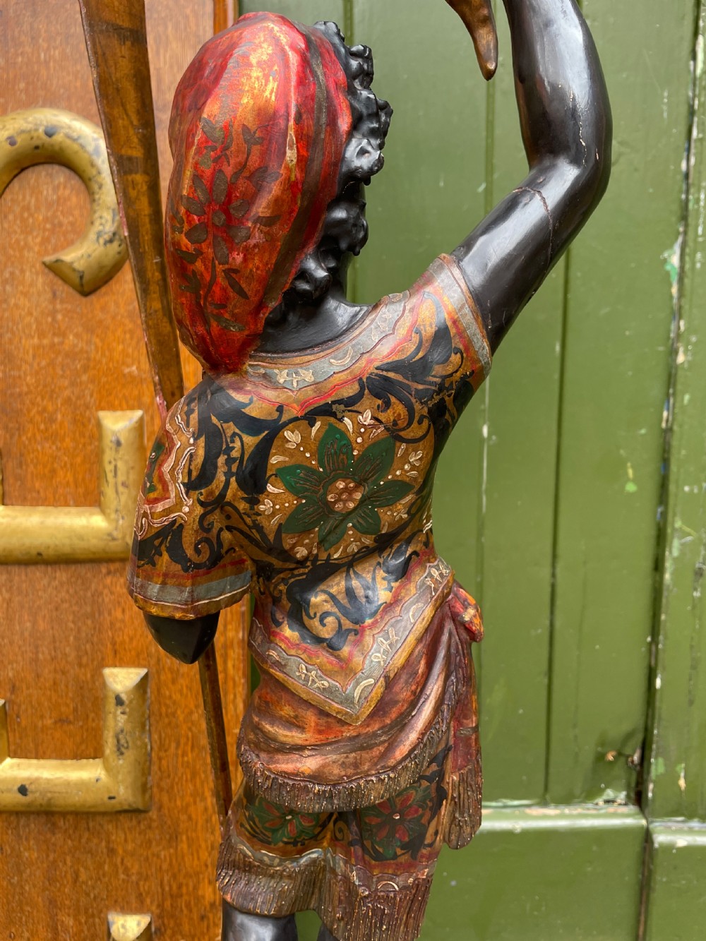 A late 19th-century Italian Venetian carved wood polychrome figure of a gondolier standing on a boat base atop a plinth, holding an oar and raised tray. View XVI