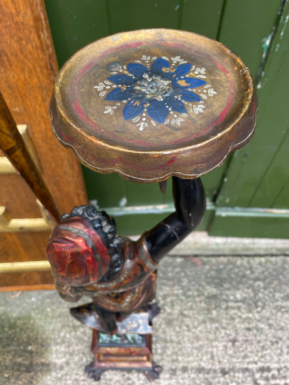 A late 19th-century Italian Venetian carved wood polychrome figure of a gondolier standing on a boat base atop a plinth, holding an oar and raised tray. View XIX
