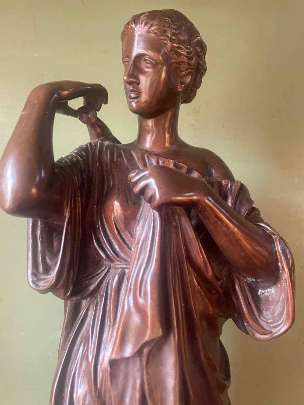 A 19th-century dark bronze sculpture depicting the classical figure of Diane de Gabii adjusting her draped robe. View VIII