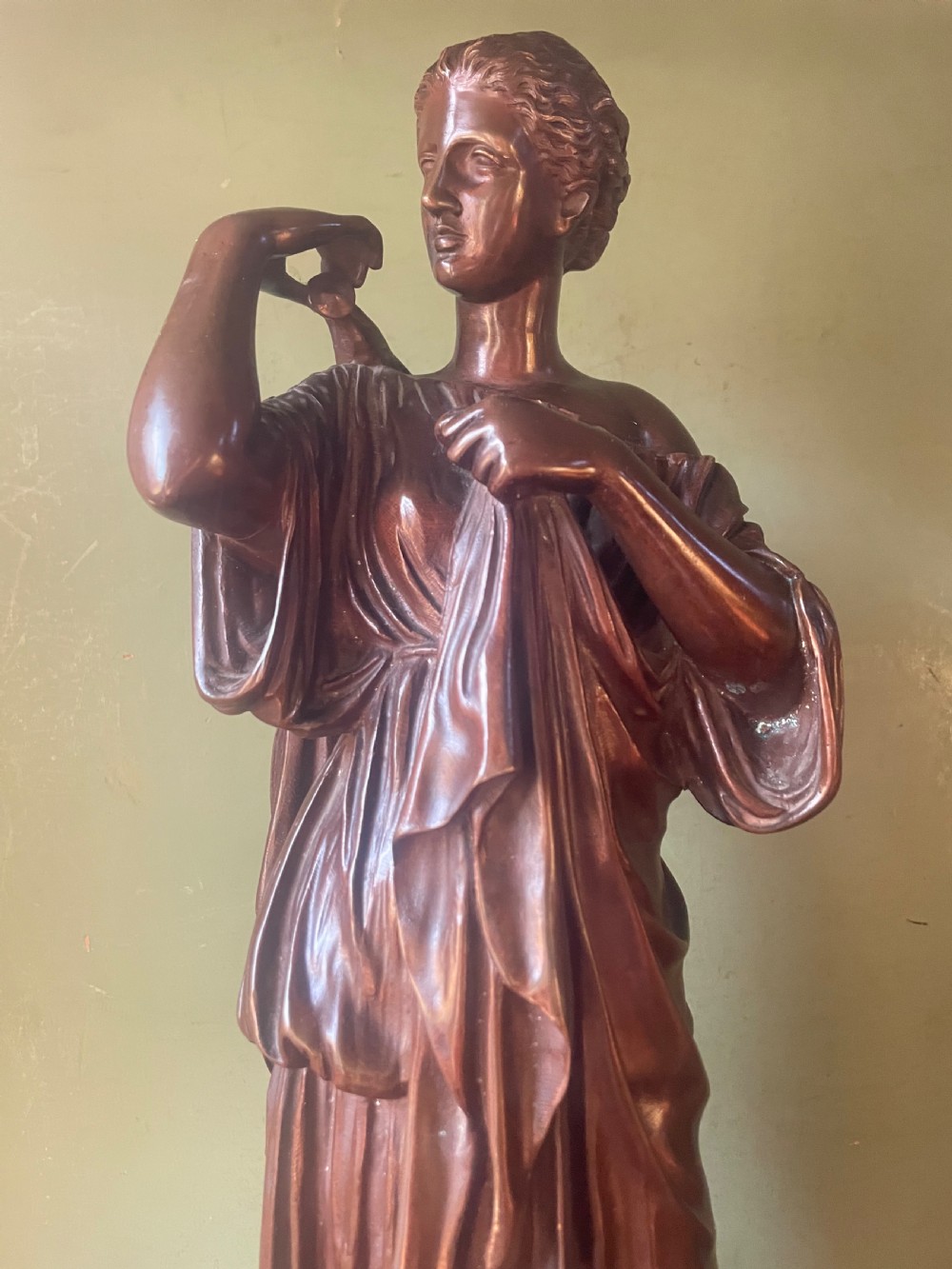 A 19th-century dark bronze sculpture depicting the classical figure of Diane de Gabii adjusting her draped robe. View XIII