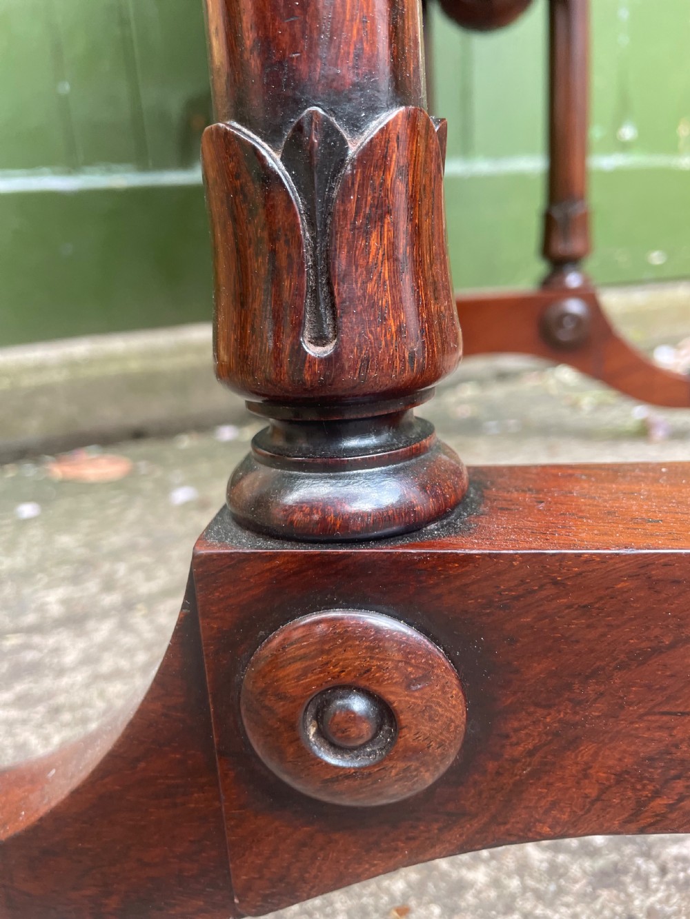 An early 19th-century George IV figured rosewood work table featuring a smooth polished top, single drawer, fabric work basket, turned twin-column supports, and brass castors. View XXIV