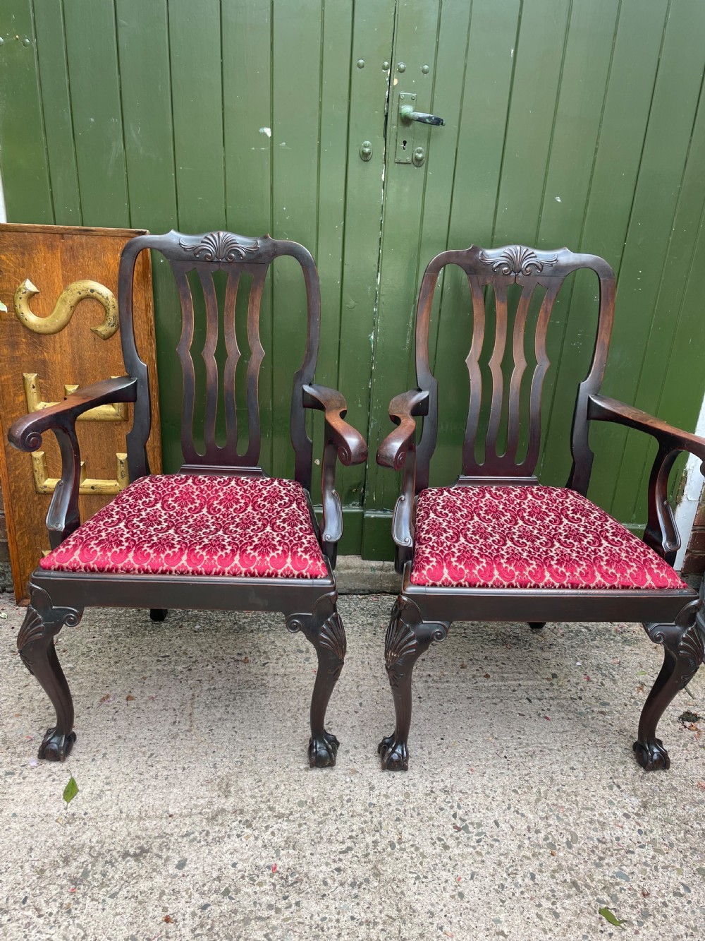 A pair of 19th-century mahogany open armchairs featuring carved shell cresting, pierced vertical splats, patterned red velvet seats, and cabriole legs with claw and ball feet. View III