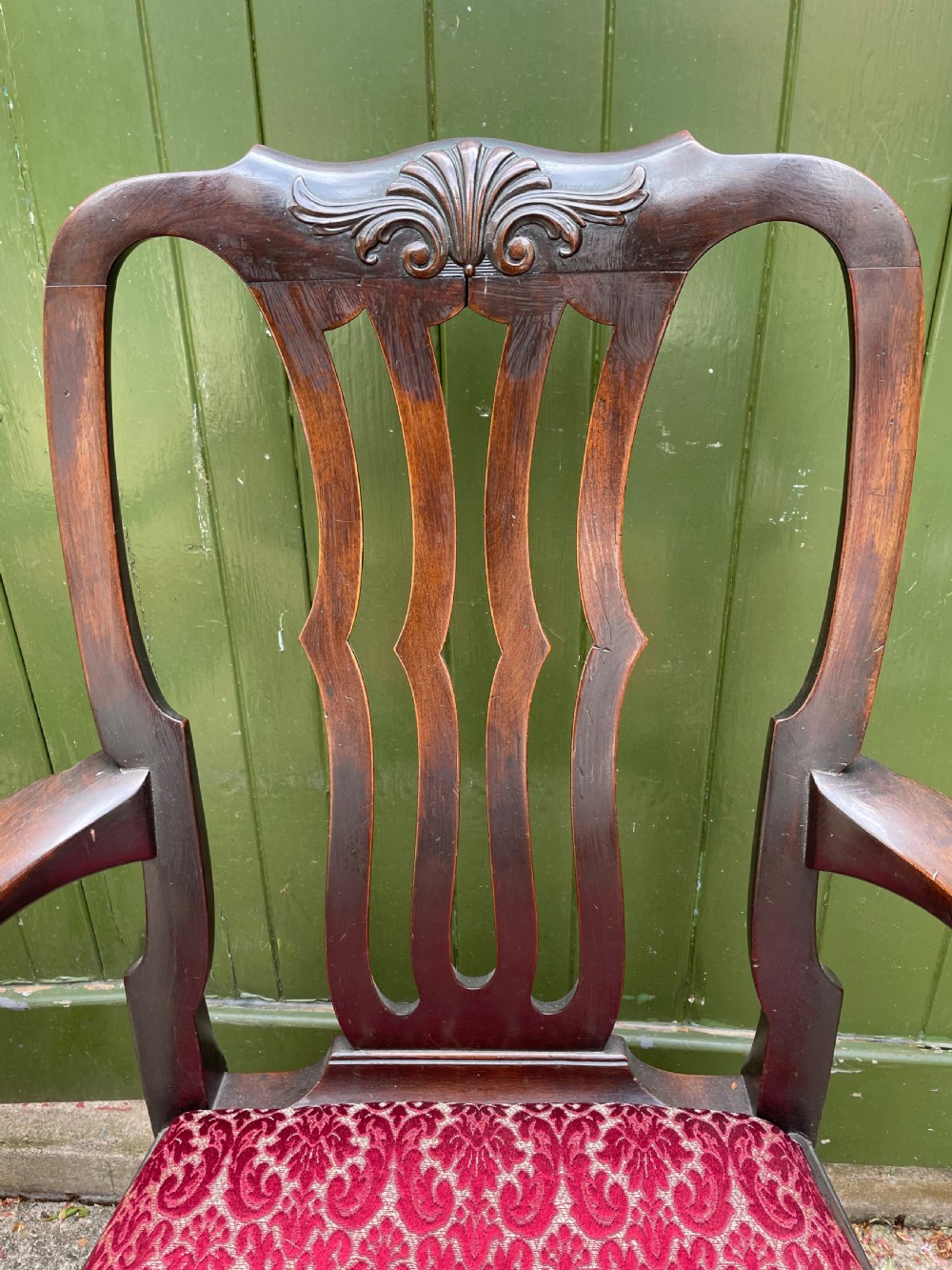 A pair of 19th-century mahogany open armchairs featuring carved shell cresting, pierced vertical splats, patterned red velvet seats, and cabriole legs with claw and ball feet. View VIII