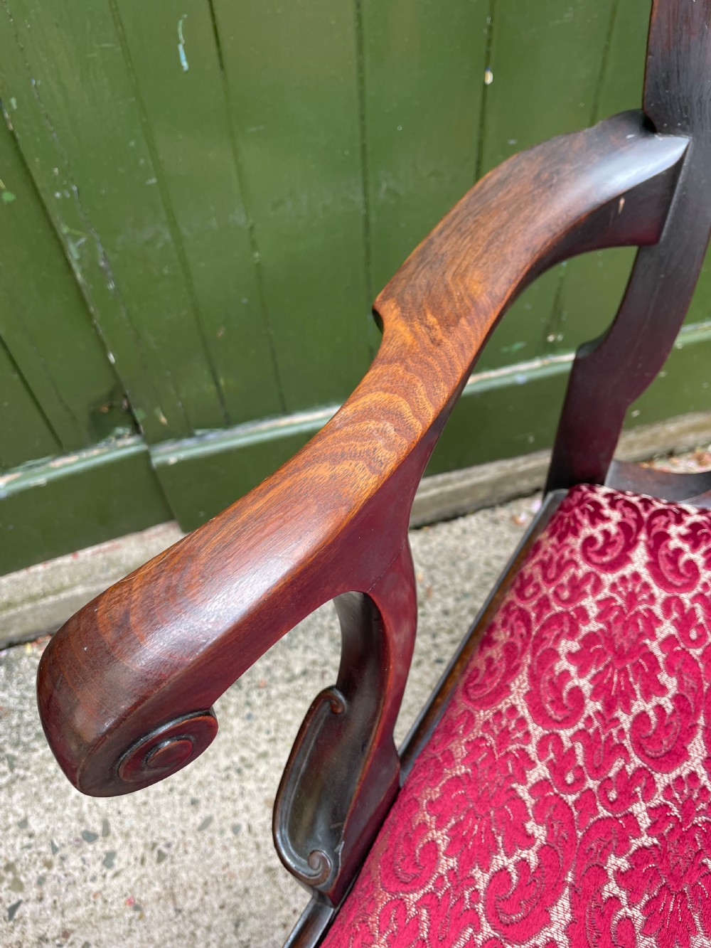 A pair of 19th-century mahogany open armchairs featuring carved shell cresting, pierced vertical splats, patterned red velvet seats, and cabriole legs with claw and ball feet. View X