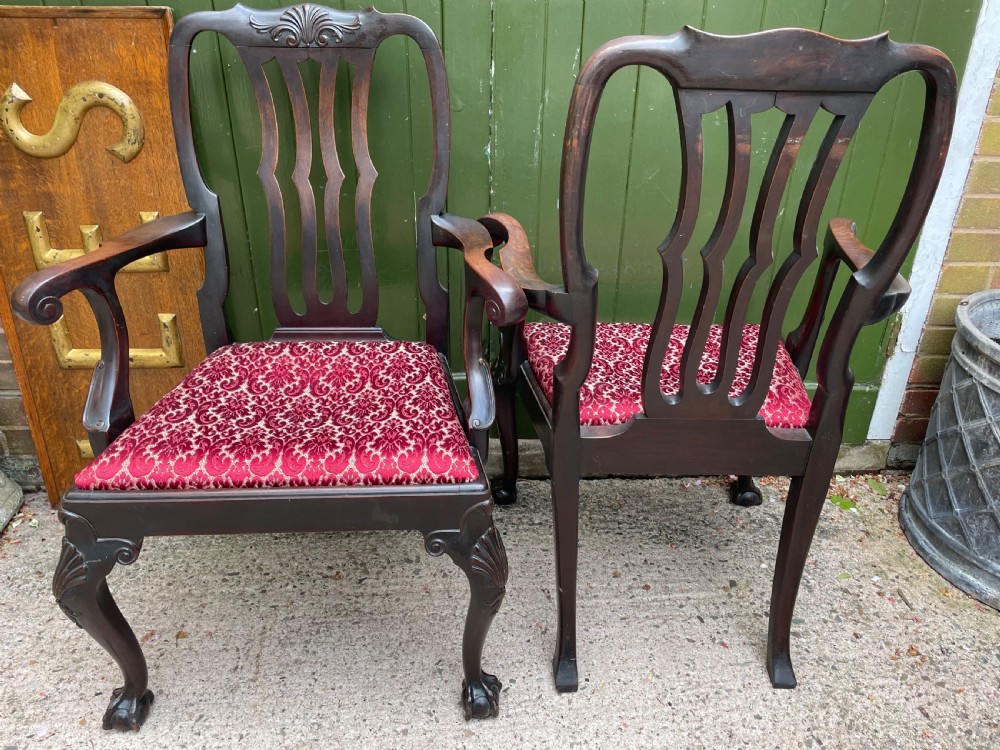 A pair of 19th-century mahogany open armchairs featuring carved shell cresting, pierced vertical splats, patterned red velvet seats, and cabriole legs with claw and ball feet. View XIII