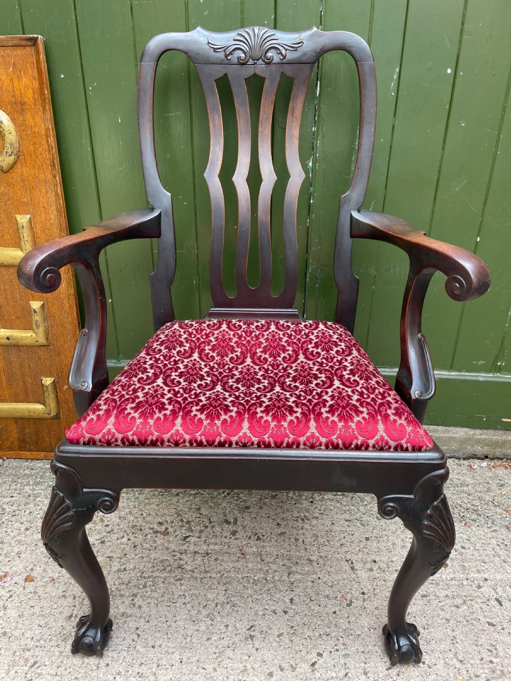 A pair of 19th-century mahogany open armchairs featuring carved shell cresting, pierced vertical splats, patterned red velvet seats, and cabriole legs with claw and ball feet. View XIV