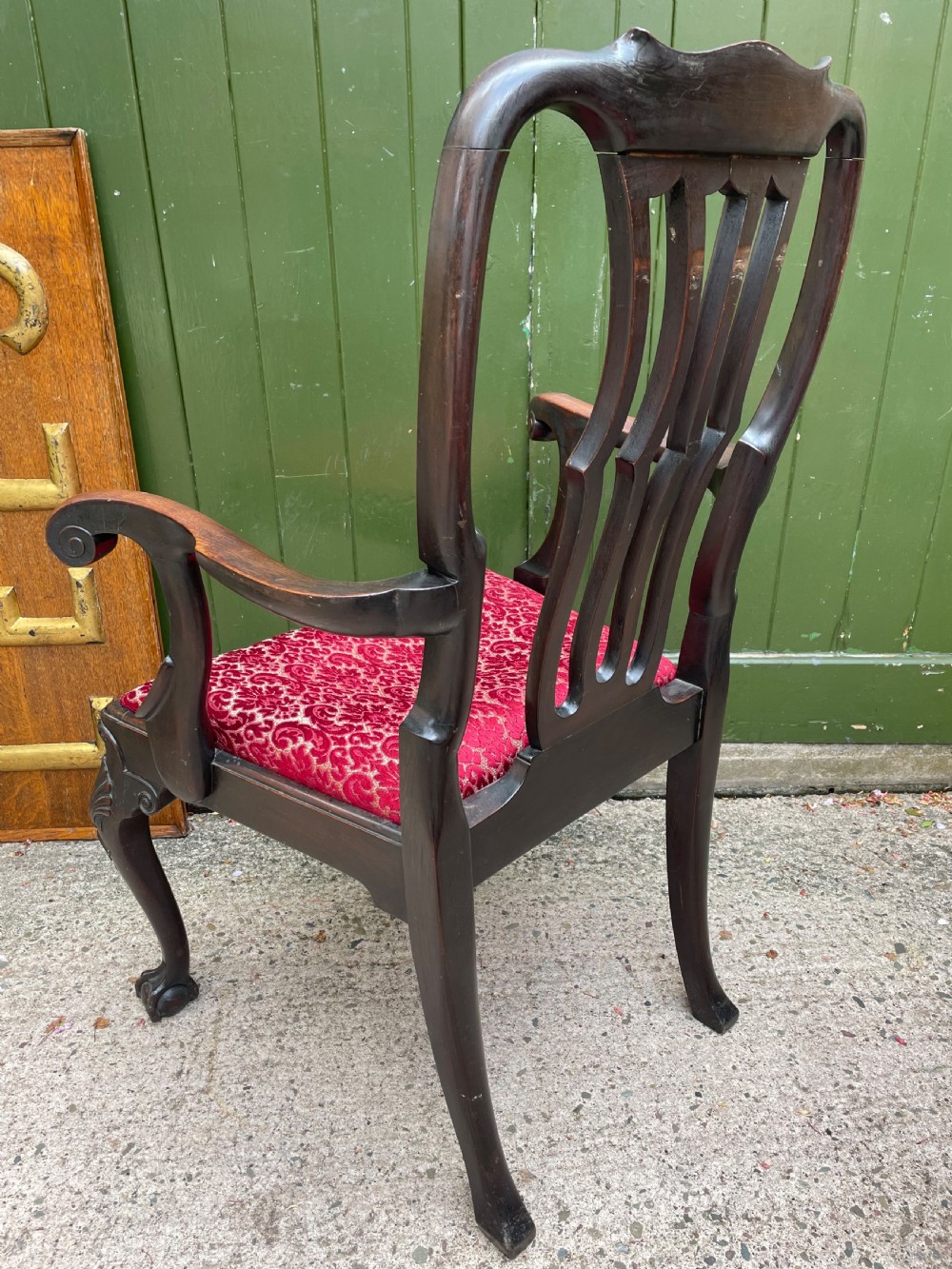A pair of 19th-century mahogany open armchairs featuring carved shell cresting, pierced vertical splats, patterned red velvet seats, and cabriole legs with claw and ball feet. View XVI