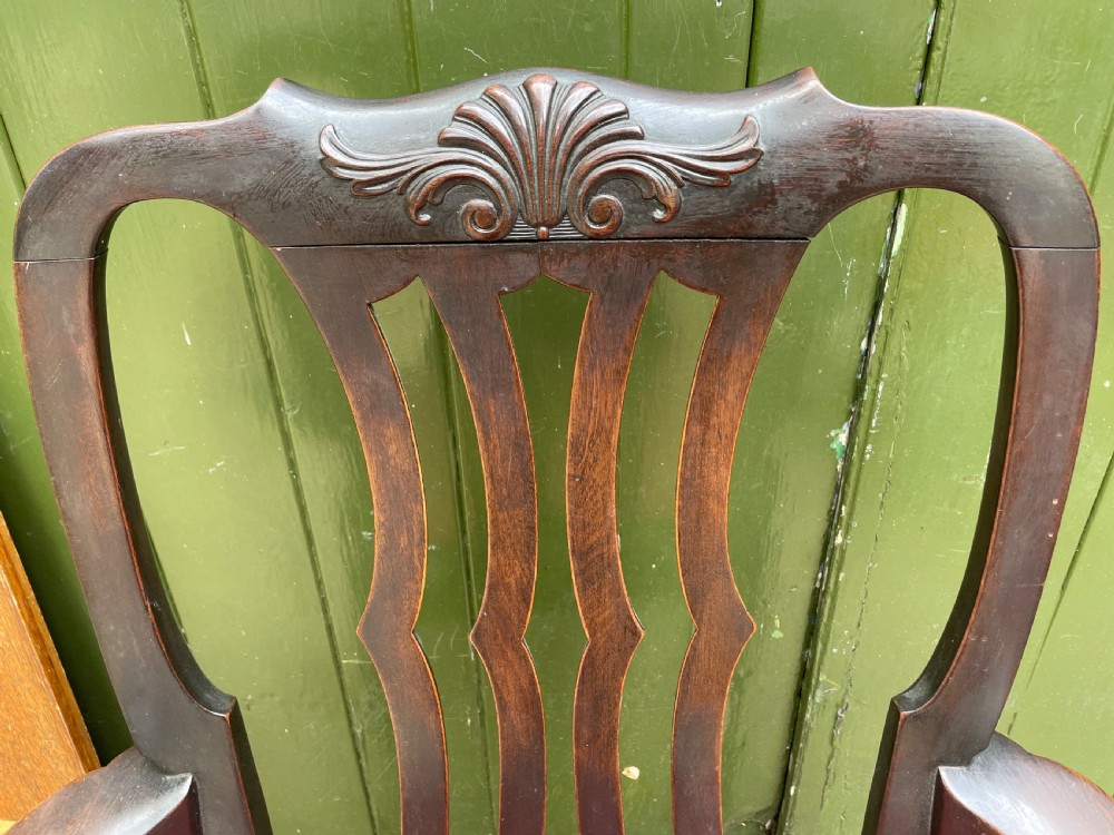 A pair of 19th-century mahogany open armchairs featuring carved shell cresting, pierced vertical splats, patterned red velvet seats, and cabriole legs with claw and ball feet. View XXII