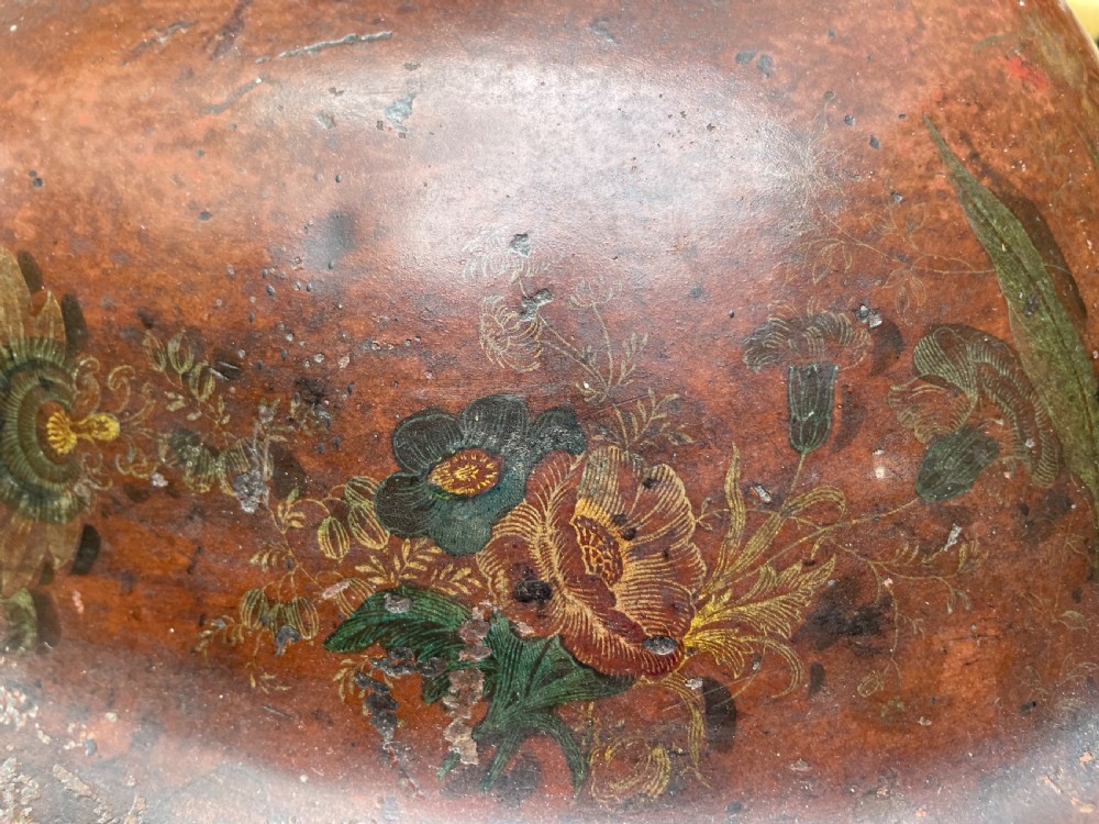 An early nineteenth-century round japanned tinware wine cooler with a domed lid, pedestal base, twin loop handles, and faded painted floral motifs. View XXI