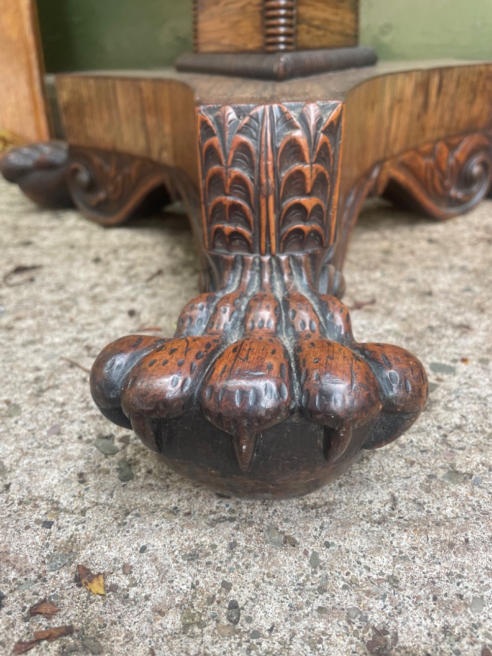 An early nineteenth-century George IV rosewood work table featuring a star-inlaid top, a single drawer casing, a tapered reeded column, and a tripartite base supported by carved claw feet. View VI