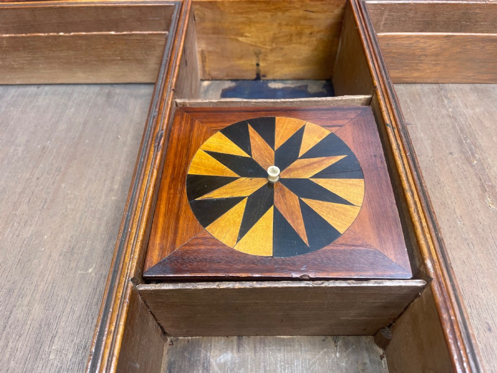 An early nineteenth-century George IV rosewood work table featuring a star-inlaid top, a single drawer casing, a tapered reeded column, and a tripartite base supported by carved claw feet. View X