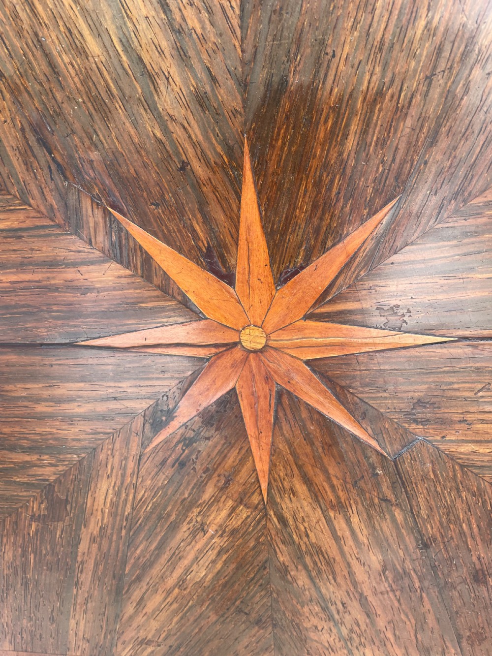 An early nineteenth-century George IV rosewood work table featuring a star-inlaid top, a single drawer casing, a tapered reeded column, and a tripartite base supported by carved claw feet. View XIV