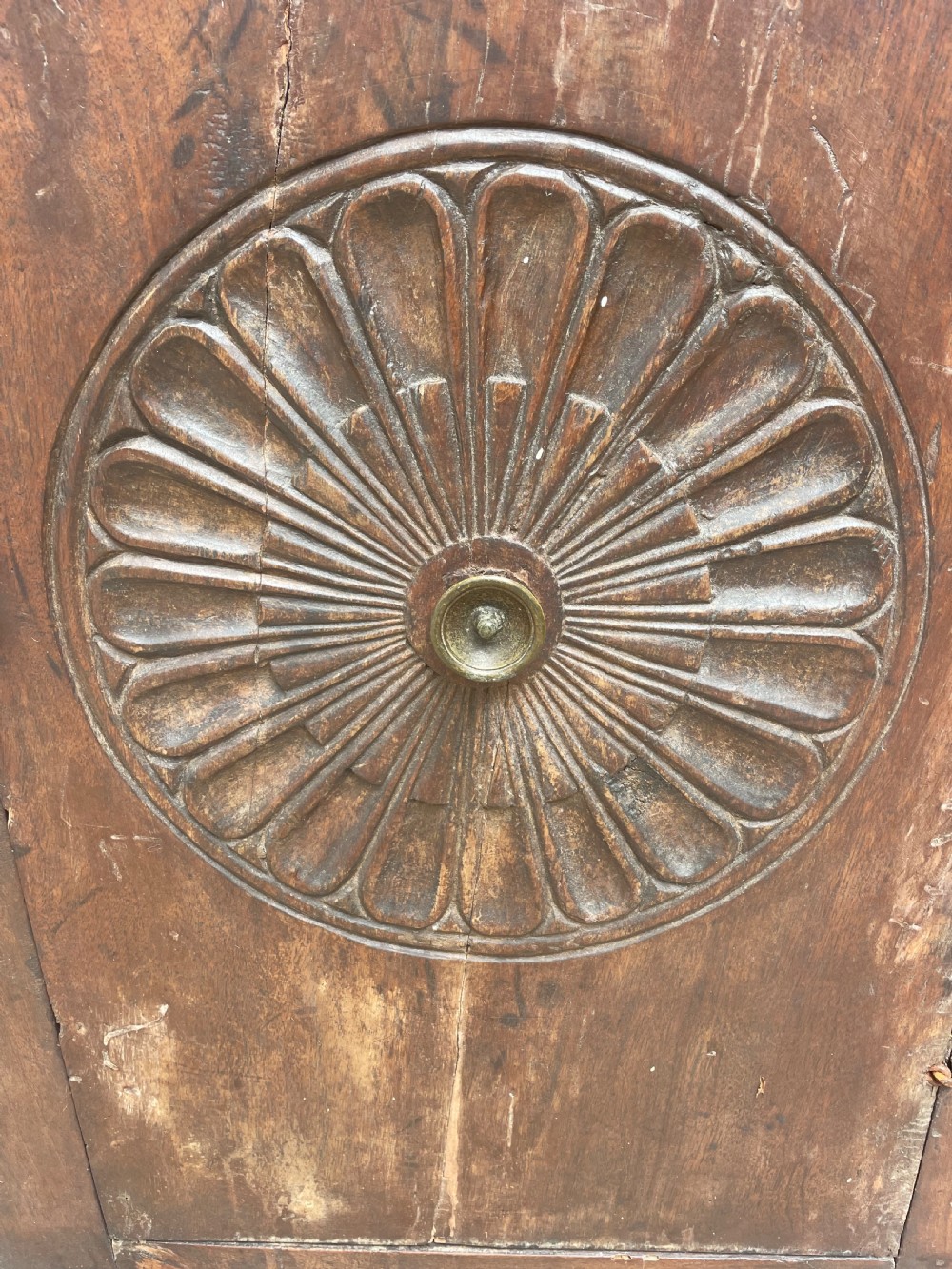 An early 18th-century Italian Tuscan walnut pedestal cupboard featuring a single cupboard door carved with a central circular rosette motif and framed by architectural moulding on a plinth base. View VI