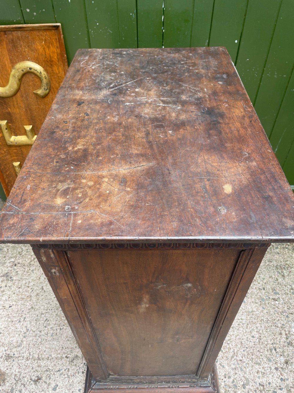 An early 18th-century Italian Tuscan walnut pedestal cupboard featuring a single cupboard door carved with a central circular rosette motif and framed by architectural moulding on a plinth base. View XVI