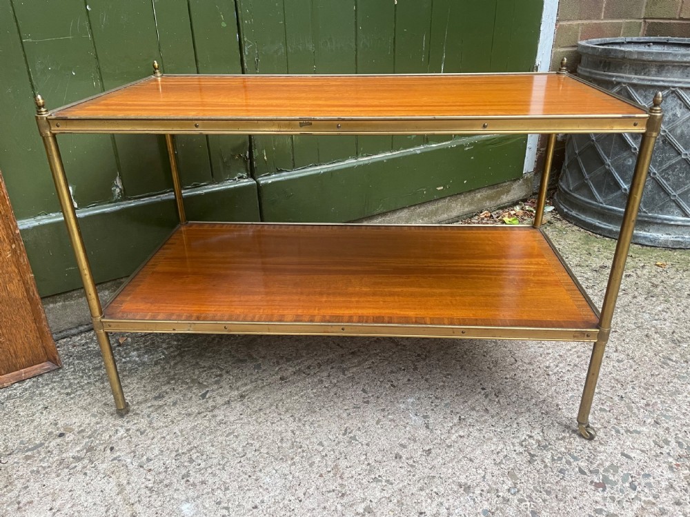 A low rectangular two-tier etagere table featuring satinwood shelves with decorative crossbanded inlay and a brass frame on castors. View XIV