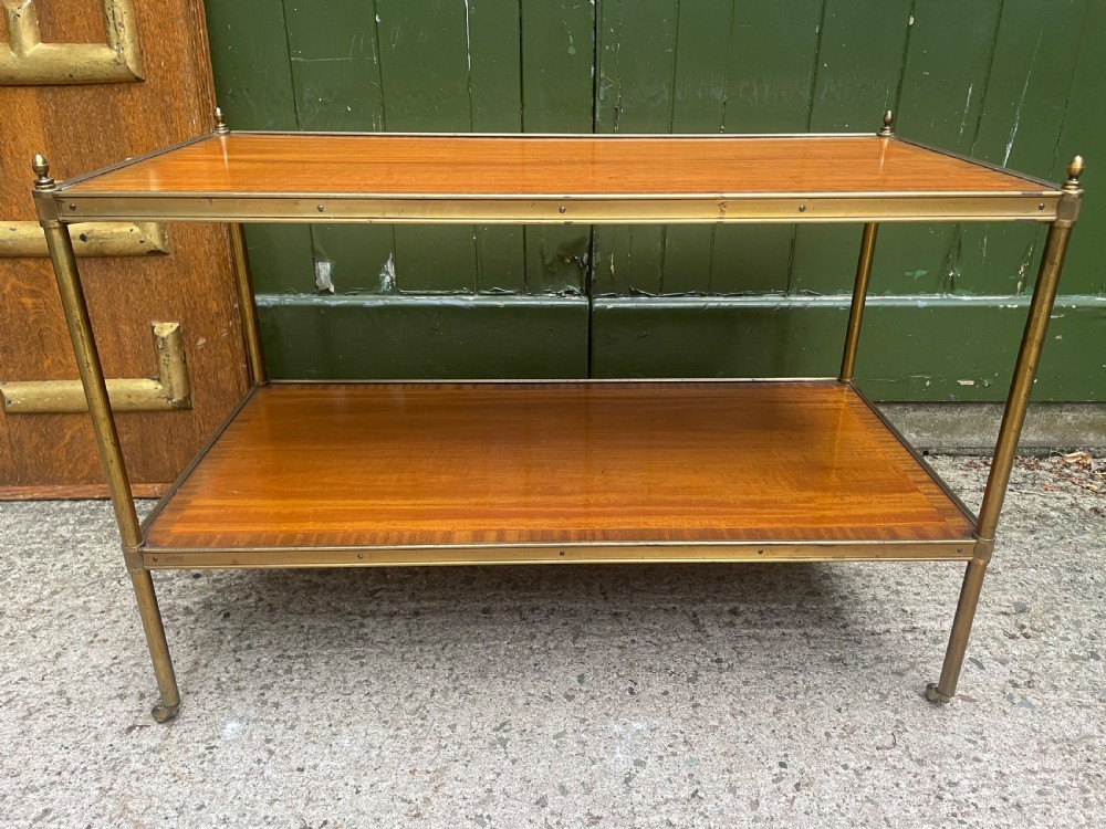 A low rectangular two-tier etagere table featuring satinwood shelves with decorative crossbanded inlay and a brass frame on castors. View XV