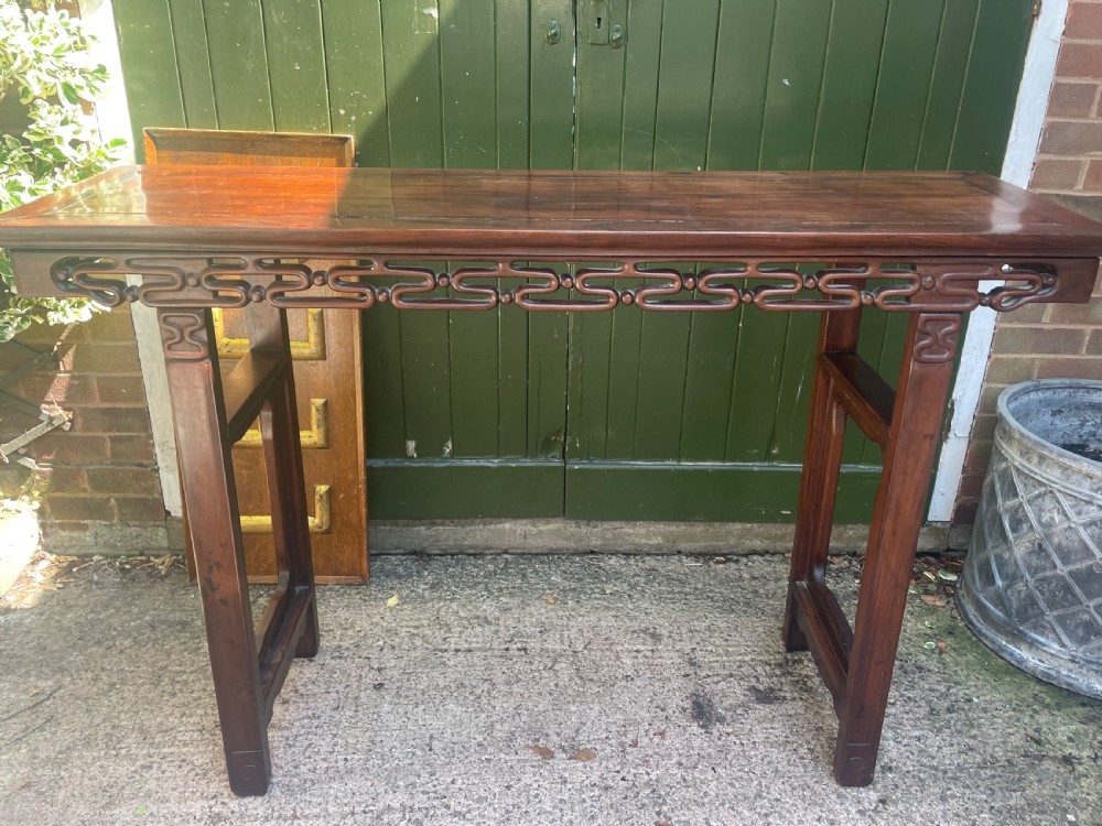 A late nineteenth-century Chinese carved hardwood altar table with an openwork apron and straight legs. View II