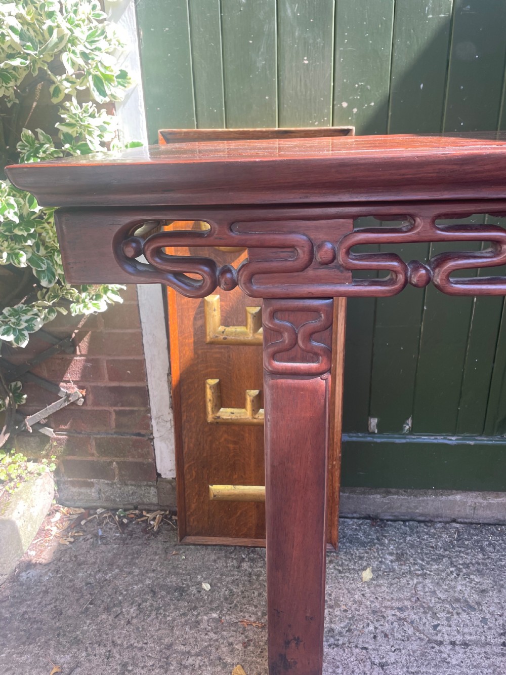 A late nineteenth-century Chinese carved hardwood altar table with an openwork apron and straight legs. View IV