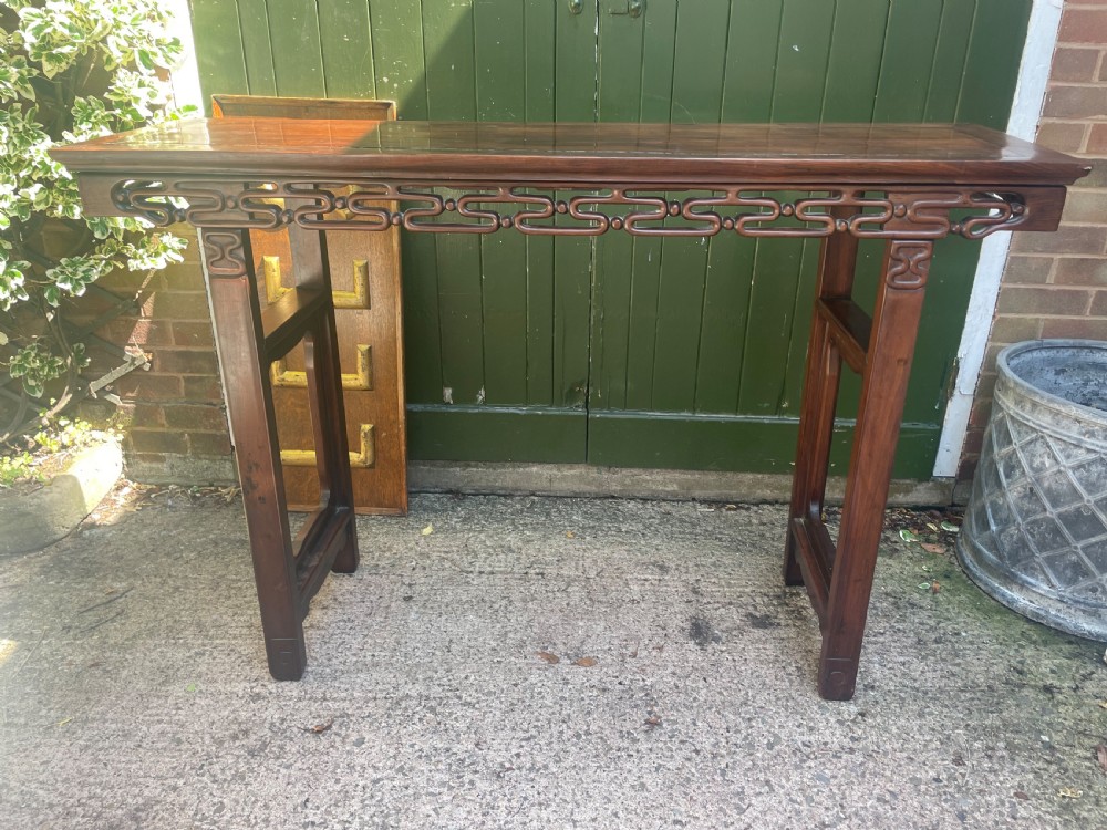 A late nineteenth-century Chinese carved hardwood altar table with an openwork apron and straight legs. View VI