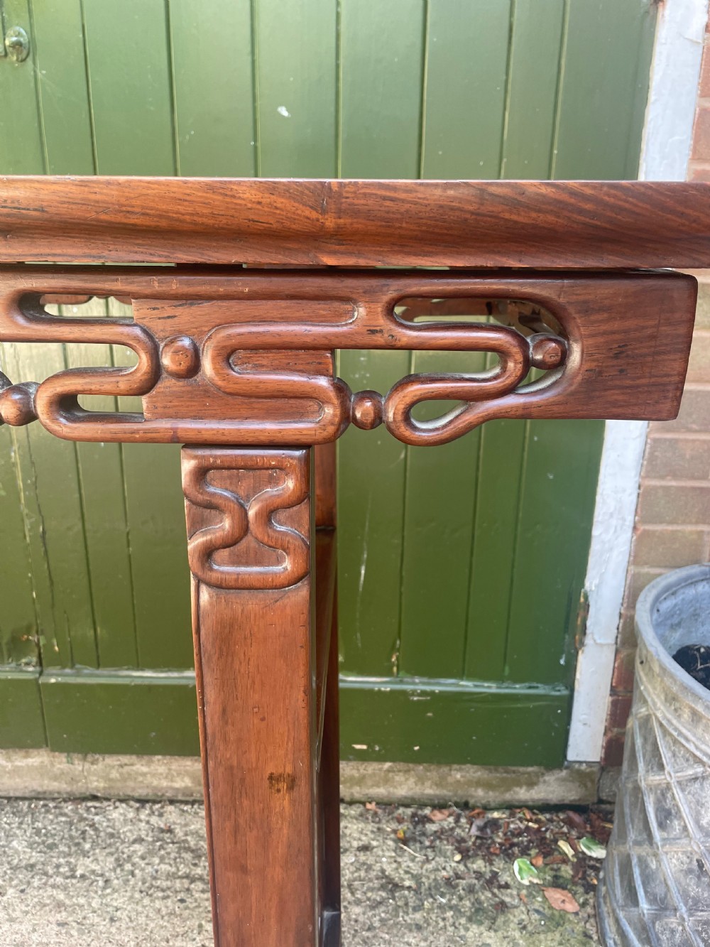 A late nineteenth-century Chinese carved hardwood altar table with an openwork apron and straight legs. View VII