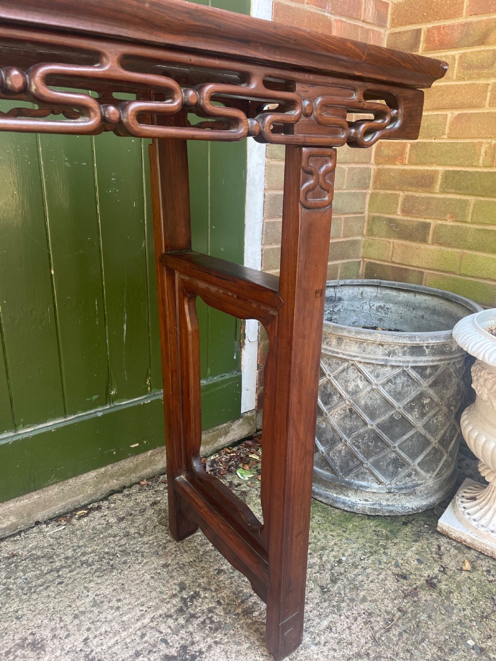 A late nineteenth-century Chinese carved hardwood altar table with an openwork apron and straight legs. View XIII