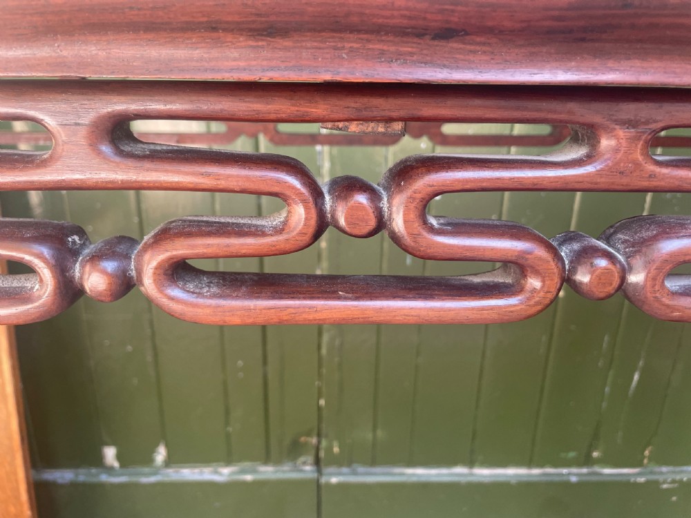 A late nineteenth-century Chinese carved hardwood altar table with an openwork apron and straight legs. View XIV
