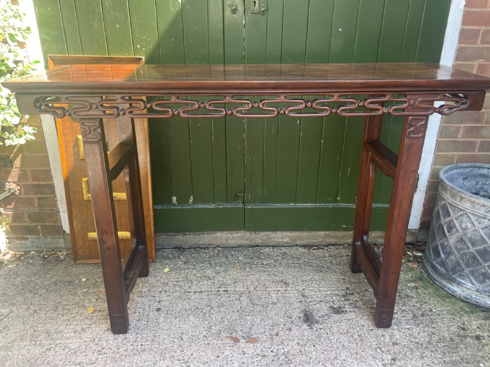 A late nineteenth-century Chinese carved hardwood altar table with an openwork apron and straight legs. View XV