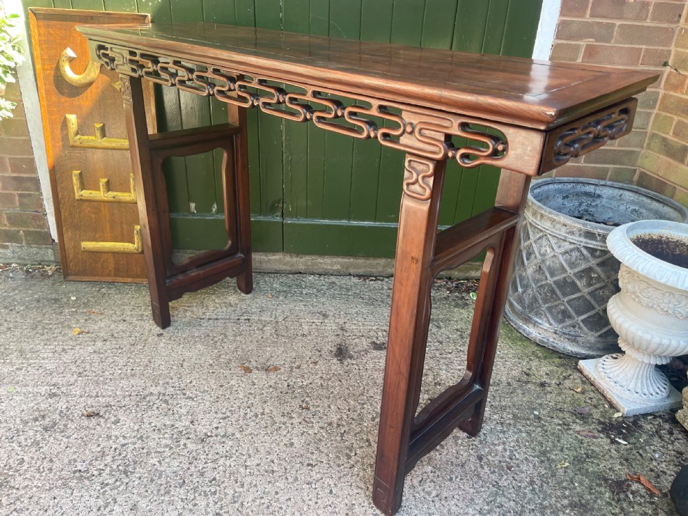 A late nineteenth-century Chinese carved hardwood altar table with an openwork apron and straight legs. View XVII
