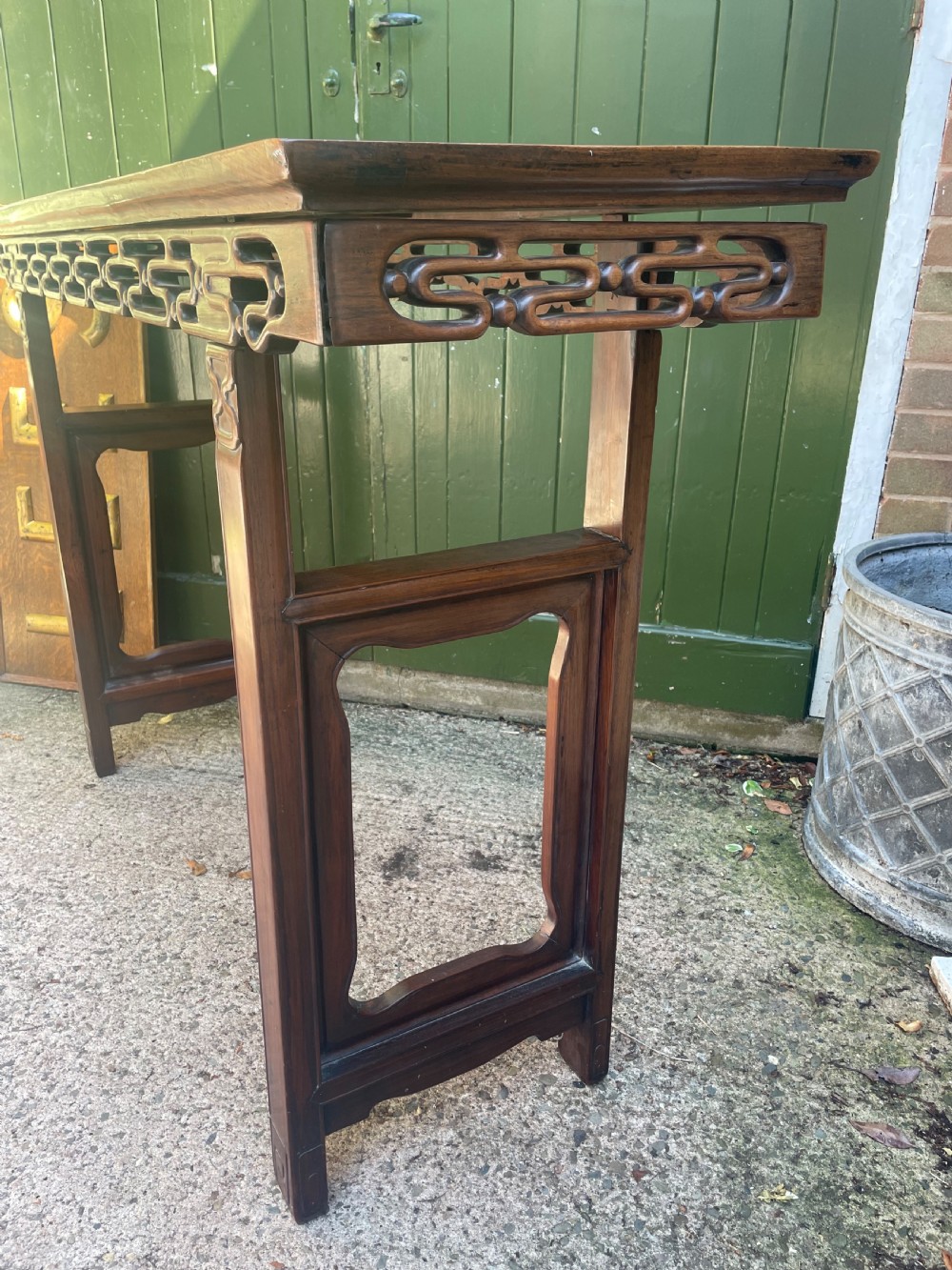 A late nineteenth-century Chinese carved hardwood altar table with an openwork apron and straight legs. View XVIII
