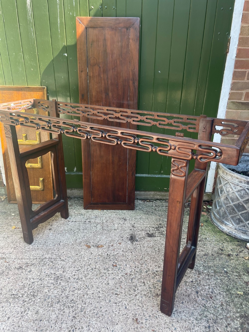 A late nineteenth-century Chinese carved hardwood altar table with an openwork apron and straight legs. View XXI