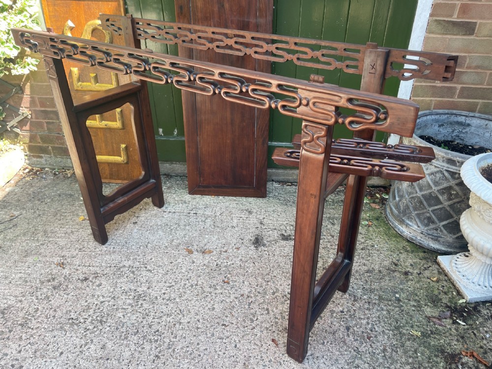 A late nineteenth-century Chinese carved hardwood altar table with an openwork apron and straight legs. View XXII