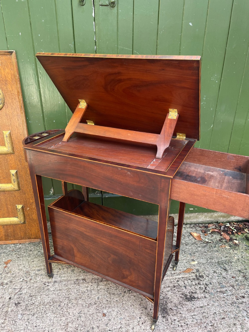 A late 18th-century George III Sheraton mahogany cheveret writing desk featuring a removable upper drawer section with an arched handle, line inlay, and tapered square legs on castors. View VII