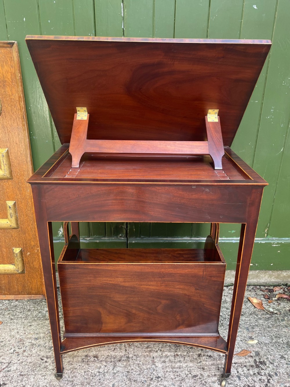 A late 18th-century George III Sheraton mahogany cheveret writing desk featuring a removable upper drawer section with an arched handle, line inlay, and tapered square legs on castors. View IX