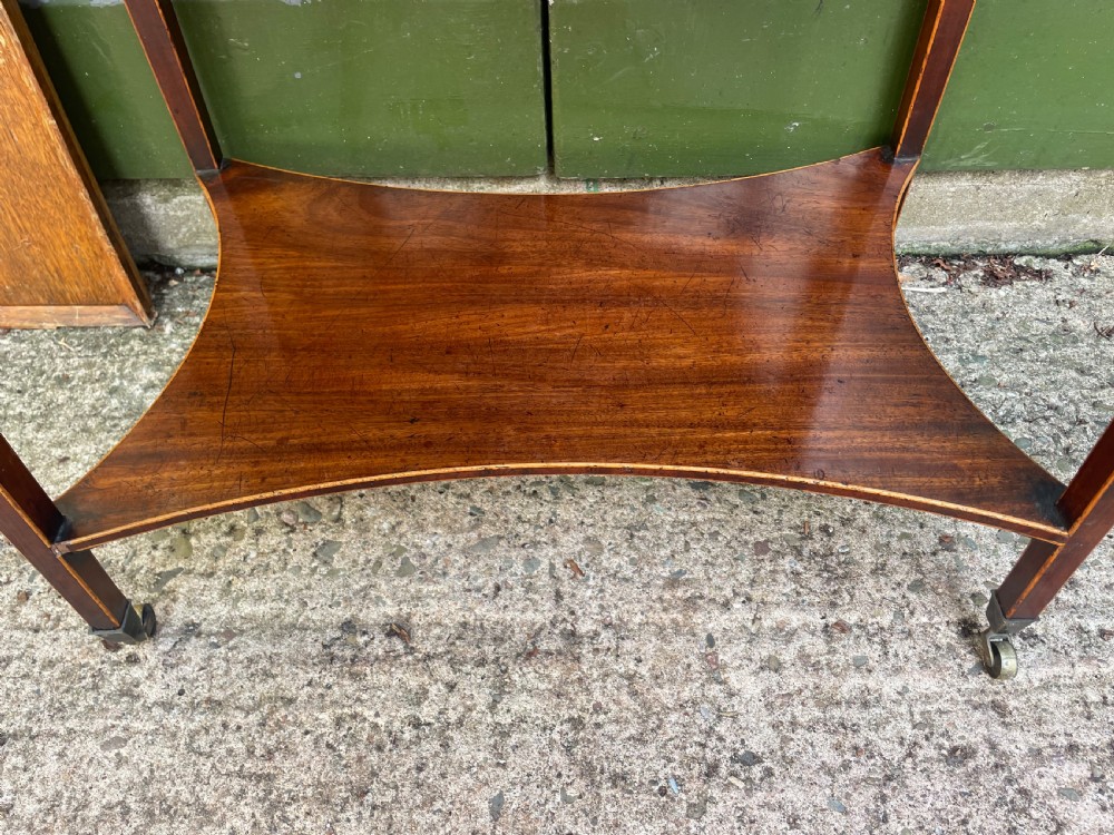 A late 18th-century George III Sheraton mahogany cheveret writing desk featuring a removable upper drawer section with an arched handle, line inlay, and tapered square legs on castors. View XVI