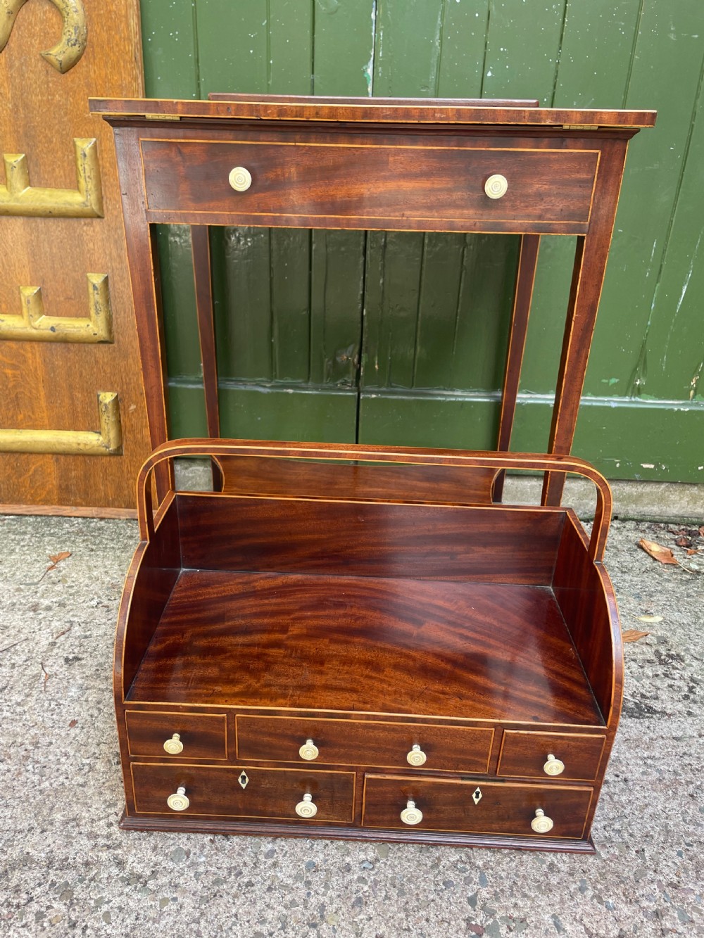 A late 18th-century George III Sheraton mahogany cheveret writing desk featuring a removable upper drawer section with an arched handle, line inlay, and tapered square legs on castors. View XIX