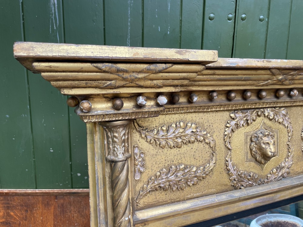 A large nineteenth-century Regency giltwood pier mirror with rope-twist side columns, a lion mask frieze, and an ebonised inner slip. View III