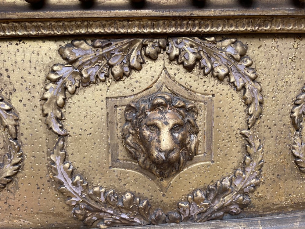 A large nineteenth-century Regency giltwood pier mirror with rope-twist side columns, a lion mask frieze, and an ebonised inner slip. View V