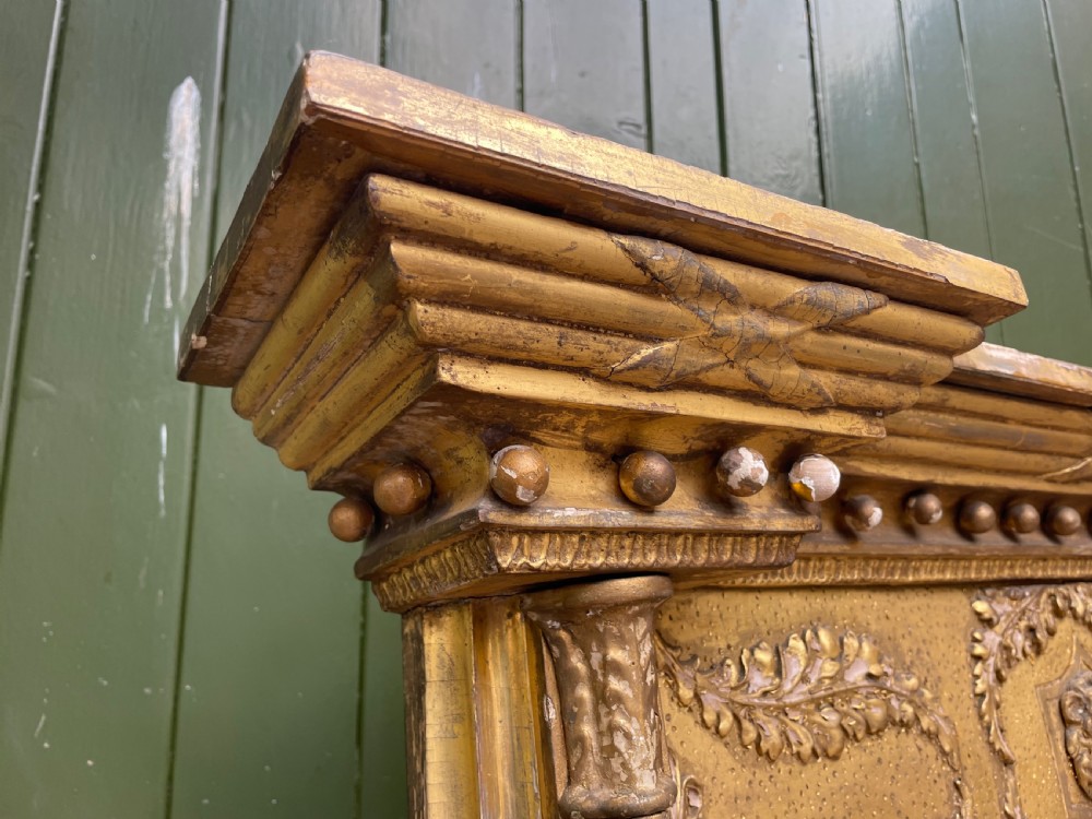 A large nineteenth-century Regency giltwood pier mirror with rope-twist side columns, a lion mask frieze, and an ebonised inner slip. View VIII