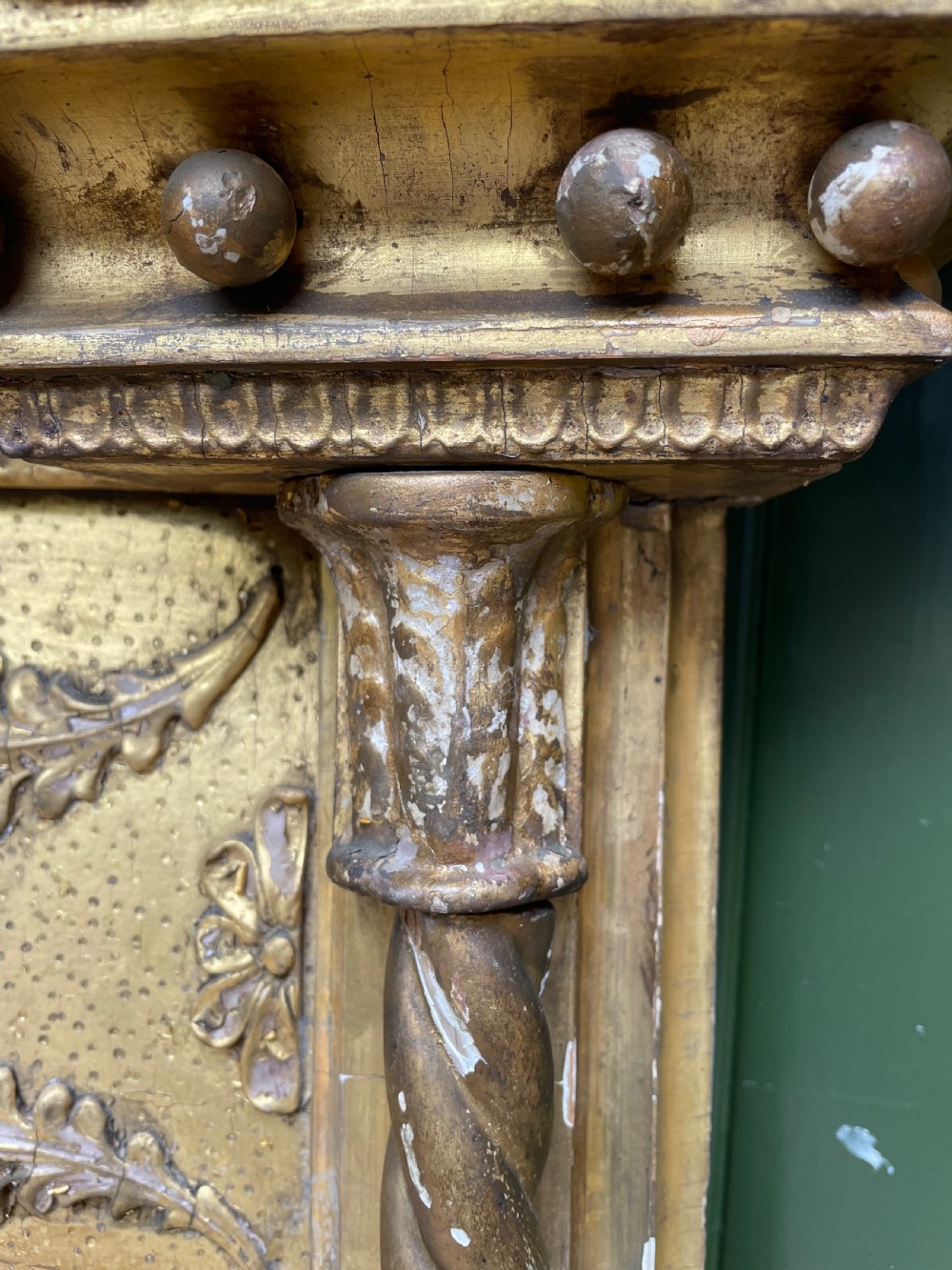A large nineteenth-century Regency giltwood pier mirror with rope-twist side columns, a lion mask frieze, and an ebonised inner slip. View X
