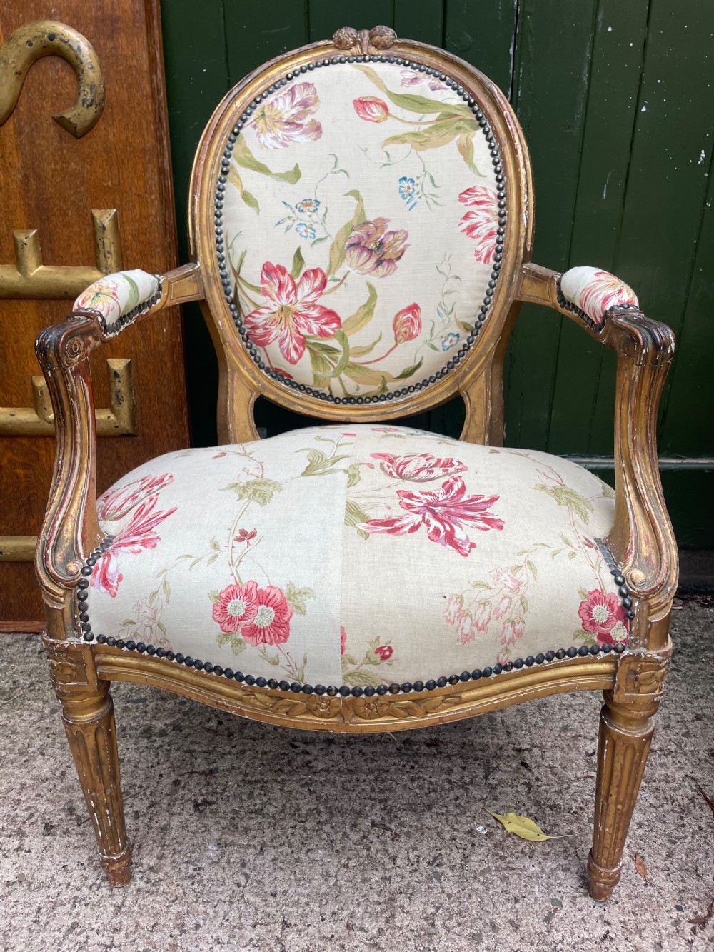 A pair of mid-19th-century French Louis XVI style giltwood salon armchairs with oval backs and floral upholstery. View III