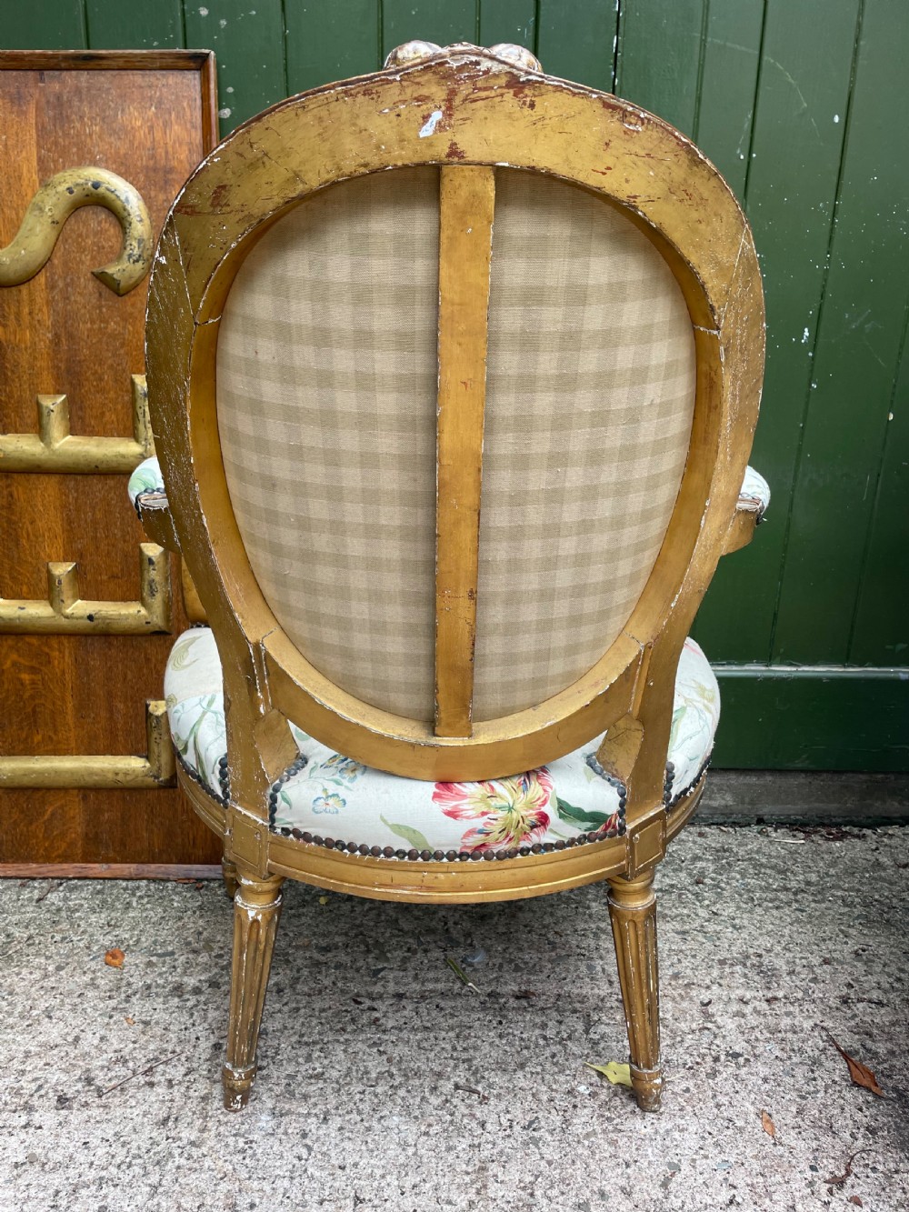 A pair of mid-19th-century French Louis XVI style giltwood salon armchairs with oval backs and floral upholstery. View VI
