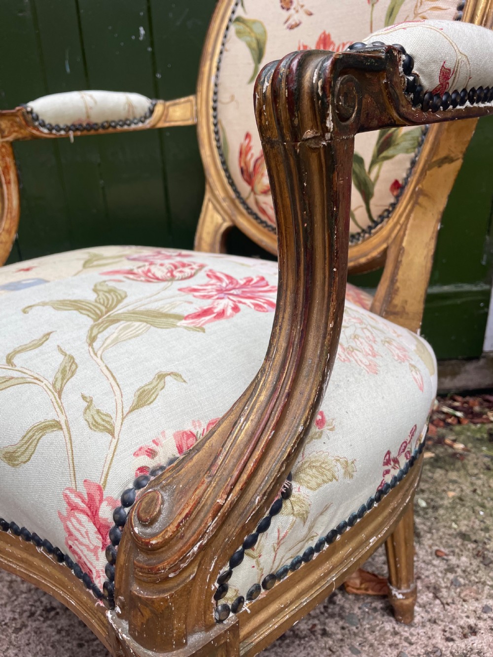 A pair of mid-19th-century French Louis XVI style giltwood salon armchairs with oval backs and floral upholstery. View VIII